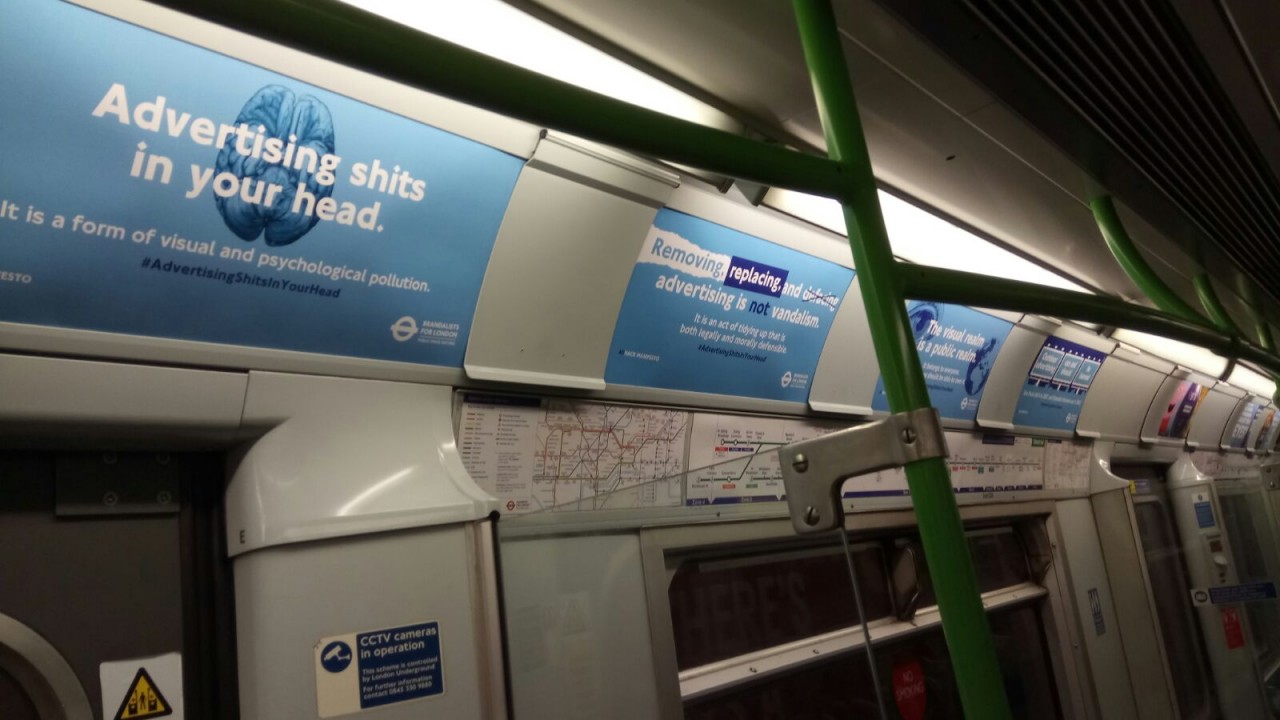 Brandalism group claiming outdoor advertising 'shits in your head' stages London Underground takeover